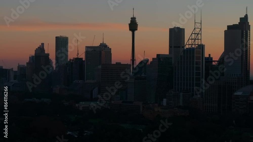 Sydney Eye Tower city stunning Vivid summer red orange sunset skyline aerial drone Royal Botanic Gardens Australia view tourist Circular Quay ferry boat scenic helicopter flight backward motion photo