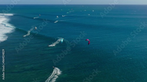 Busy surf spot with kitesurfers riding the waves in Mauritius