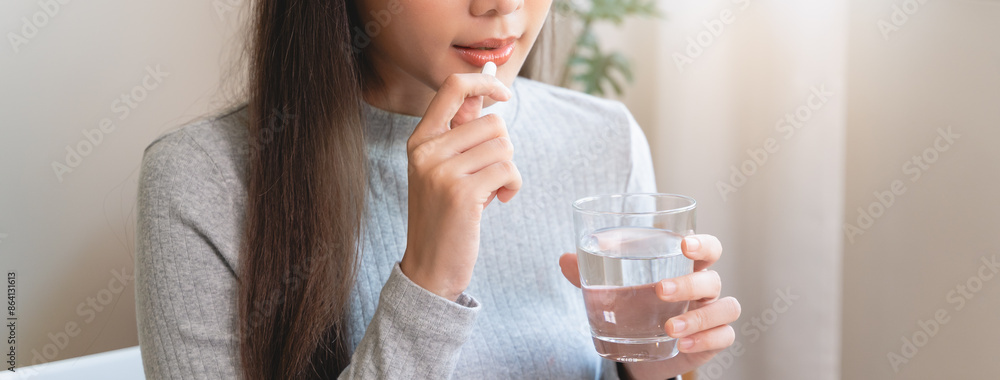 Dietary supplement, asian young woman, girl hand holding orange medical pill, take or eat vitamin C, D for treatment for skin Dietary supplement, asian young woman, girl hand holding orange medical pill, take or eat vitamin C, D for treatment for skin