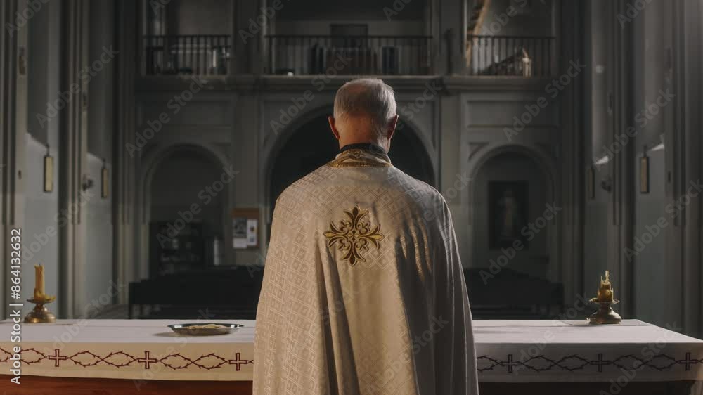Tilt down back view shot of elderly priest waling to altar in gothic dimly lit cathedral Tilt down back view shot of elderly priest waling to altar in gothic dimly lit cathedral