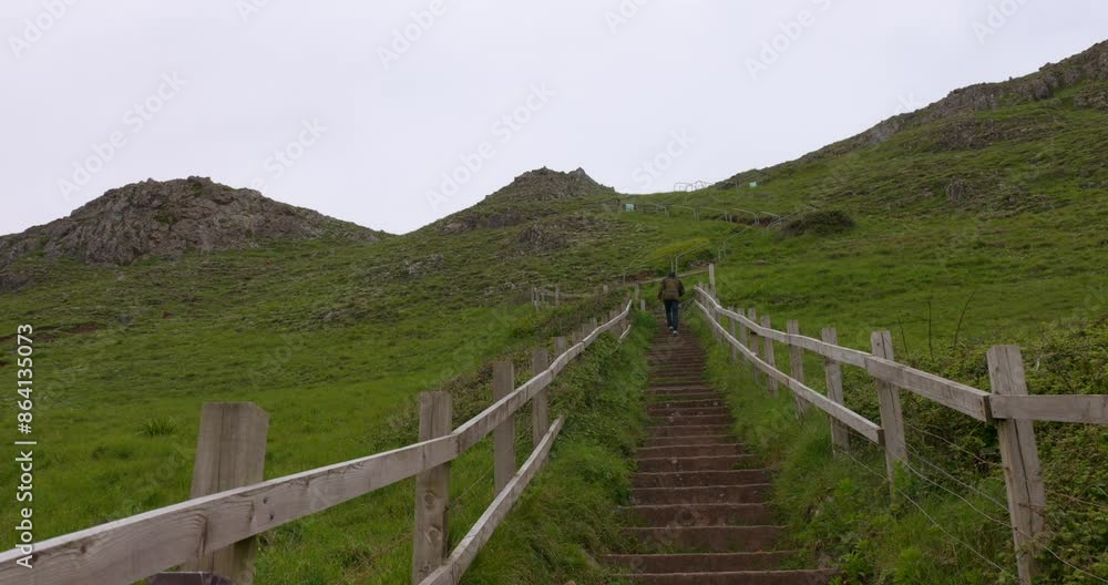 Man hiking up at Brean down stairs, England. Brean down national trust tourism area. Man hiking up at Brean down stairs, England. Brean down national trust tourism area.