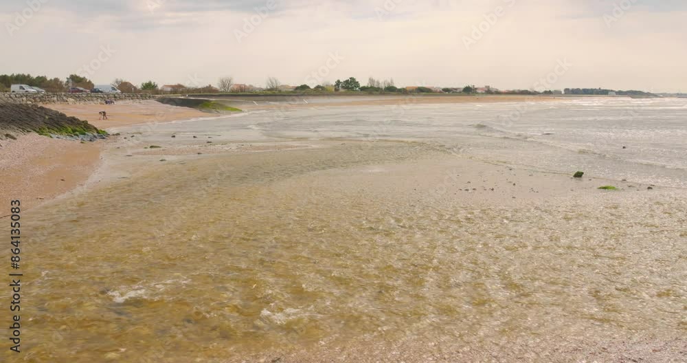 Fresh River Stream Flowing Onto The Seascape With Calm Waves. Wide Shot Fresh River Stream Flowing Onto The Seascape With Calm Waves. Wide Shot