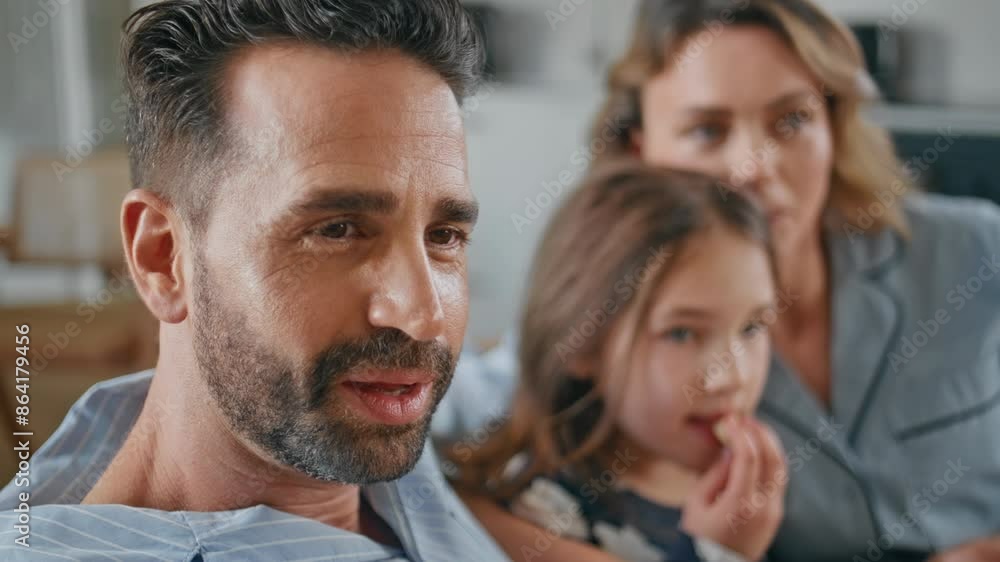 Latina man watching tv relaxing family together on sofa closeup. Happy parents Latina man watching tv relaxing family together on sofa closeup. Happy parents