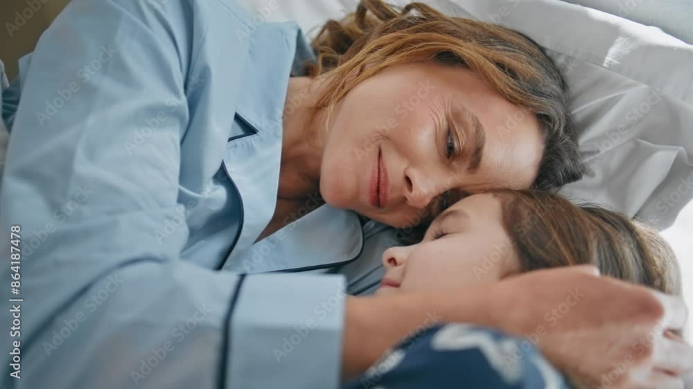 Lazy mom kid lying bedroom interior closeup. Mother and daughter in pyjamas Lazy mom kid lying bedroom interior closeup. Mother and daughter in pyjamas