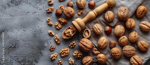 Golden Nutcracker With Whole Walnuts on Gray Background