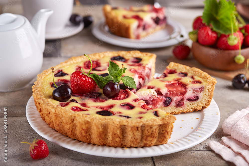 Tart with cherries strawberries and custard milk cream filling. Open cheesecake pie. Delicious homemade summer dessert with berries. Tart with cherries strawberries and custard milk cream filling. Open cheesecake pie. Delicious homemade summer dessert with berries.