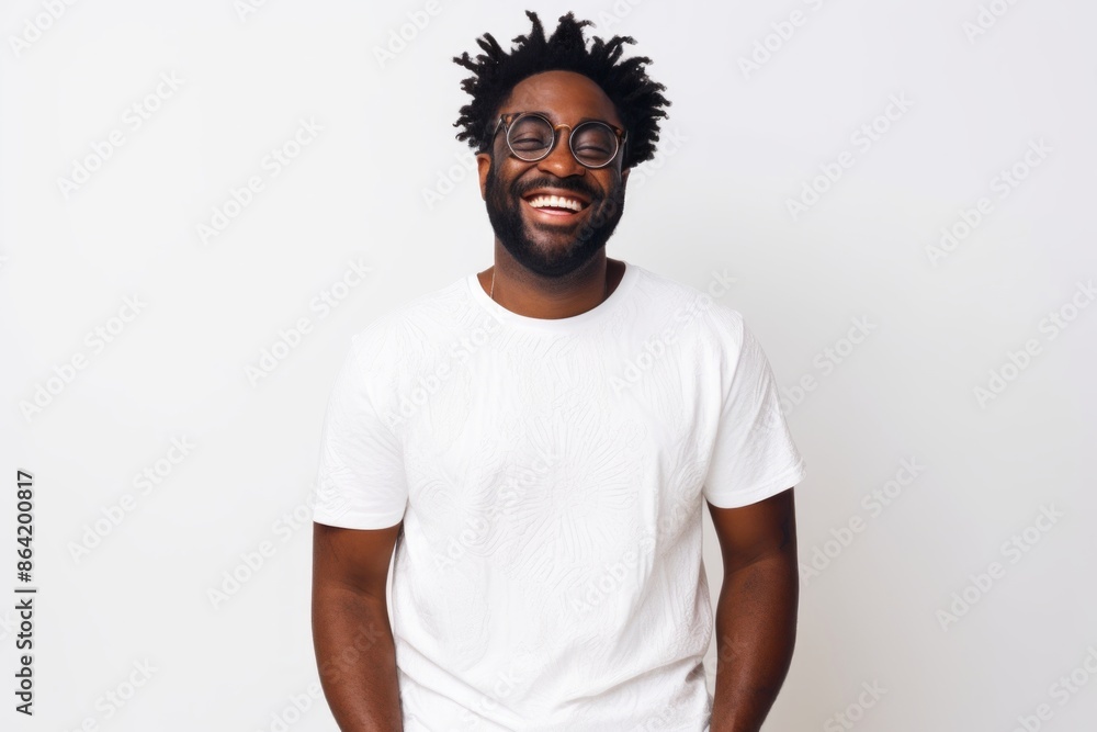 Portrait of a joyful afro-american man in his 30s donning a trendy cropped top in front of white background Portrait of a joyful afro-american man in his 30s donning a trendy cropped top in front of white background