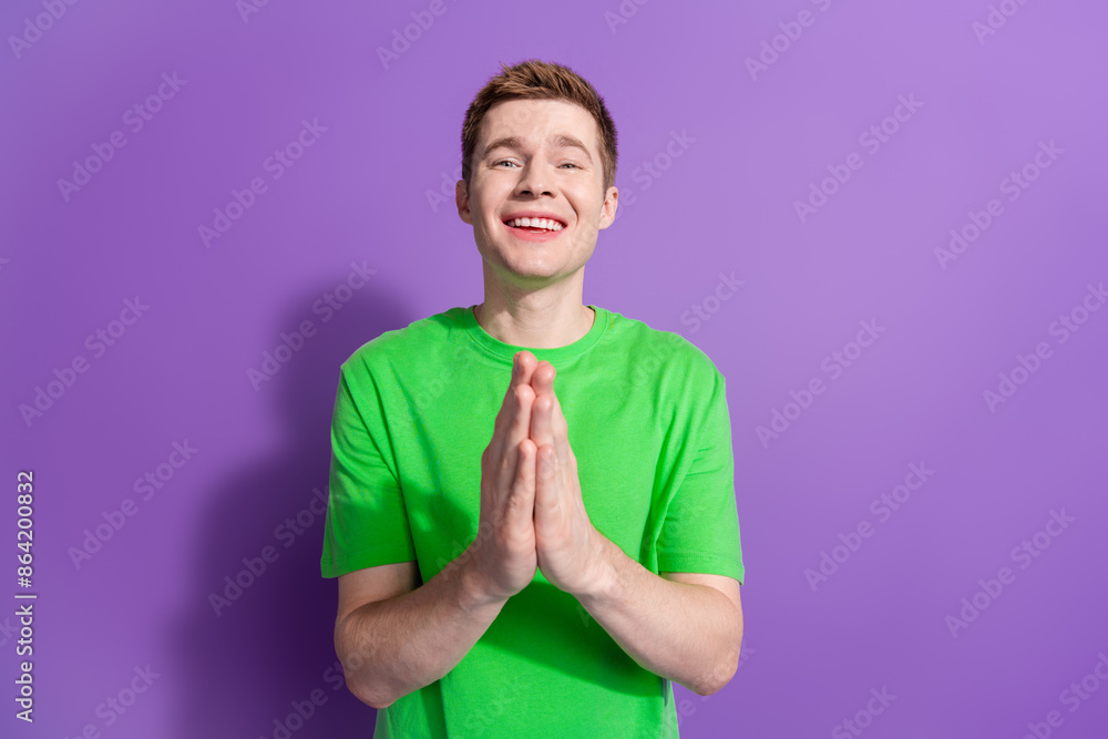 Portrait of nice young man arms plead wear t-shirt isolated on purple color background Portrait of nice young man arms plead wear t-shirt isolated on purple color background