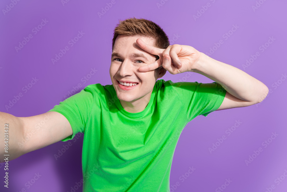 Portrait of nice young man take selfie v-sign eye wear t-shirt isolated on purple color background Portrait of nice young man take selfie v-sign eye wear t-shirt isolated on purple color background