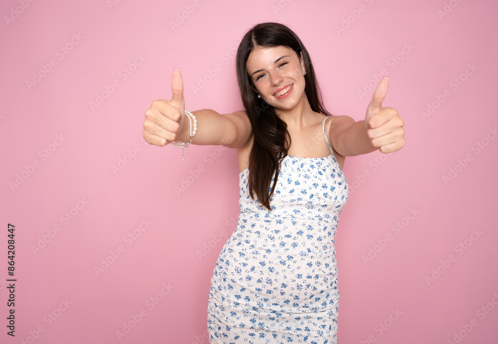 Portrait of a Young woman isolated over pink background showing thumbs up gesture. Portrait of a Young woman isolated over pink background showing thumbs up gesture.