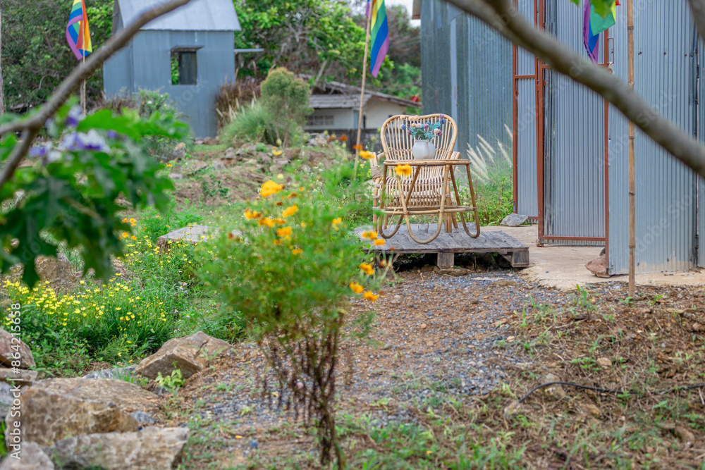The background of the park decoration has a corner and wooden chairs for sitting and relaxing during the day. Amidst a grove of flowers The background of the park decoration has a corner and wooden chairs for sitting and relaxing during the day. Amidst a grove of flowers