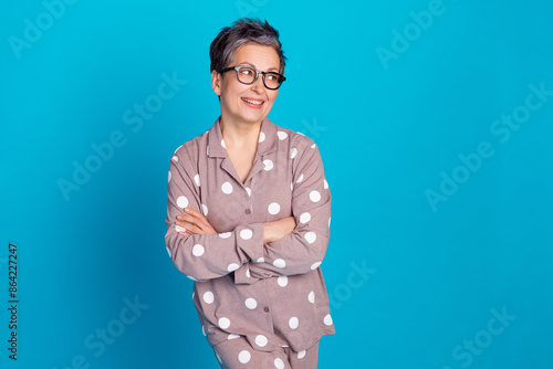 Photo of charming lovely retired woman wear stylish pajama look empty space news isolated on blue color background