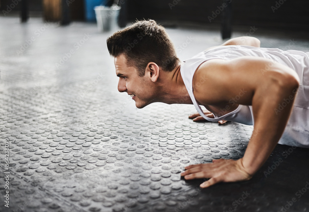 Obraz premium Push ups, floor and man with exercise in gym for power workout, fitness endurance or strength challenge. Wellness, athlete and person lifting body weight for muscle gain, training or performance