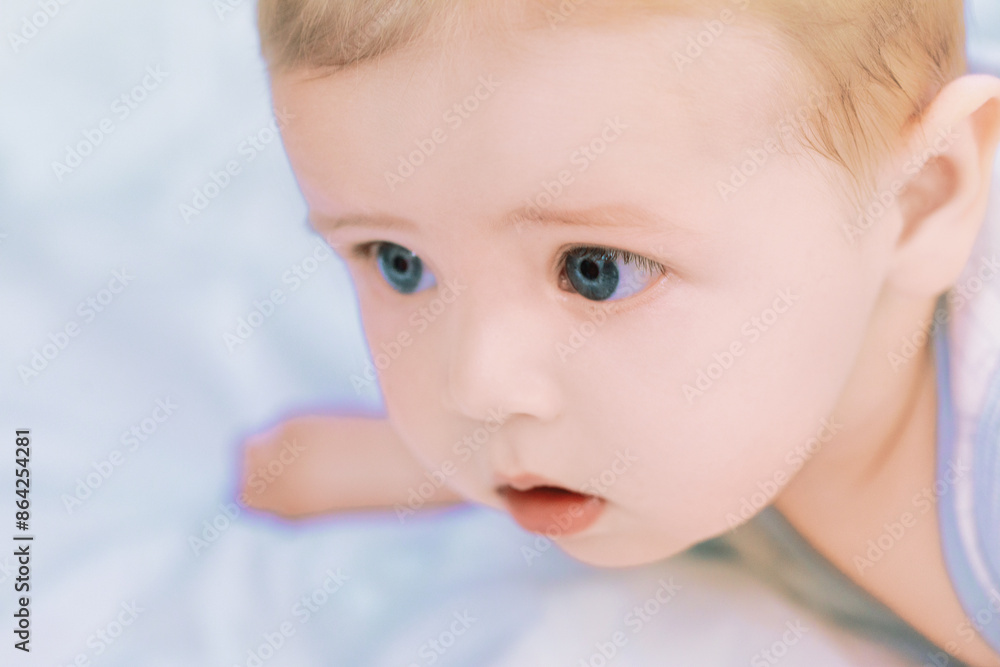 Adorable baby boy lying on stomach and looking up Adorable baby boy lying on stomach and looking up