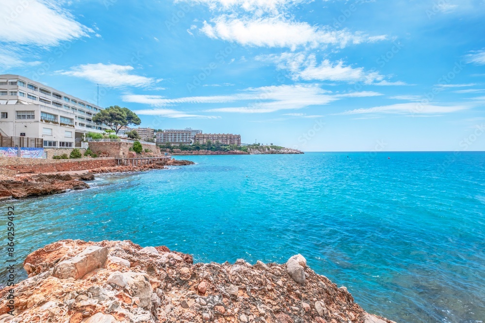 View of part of the promenade that connects the beaches of the city of Salou with the arrival of tourists Sea and palm trees in the tourist town of Costa Dorada
