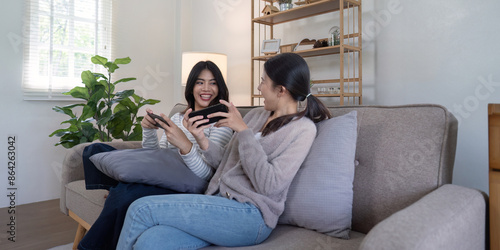 Lesbian Couple Enjoying Quality Time Playing Video Games Together in a Modern Cozy Living Room