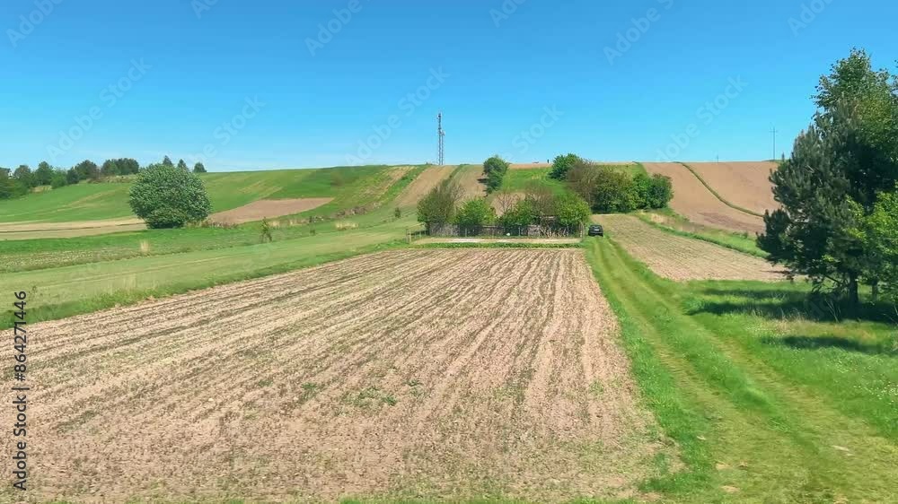 View from the train window on agricultural fields in Poland in spring. View from the train window on agricultural fields in Poland in spring.