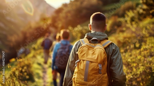 Group of backpackers hiking on a sunlit mountain trail, surrounded by nature and scenic views. Adventure and exploration in the great outdoors. © stockpro