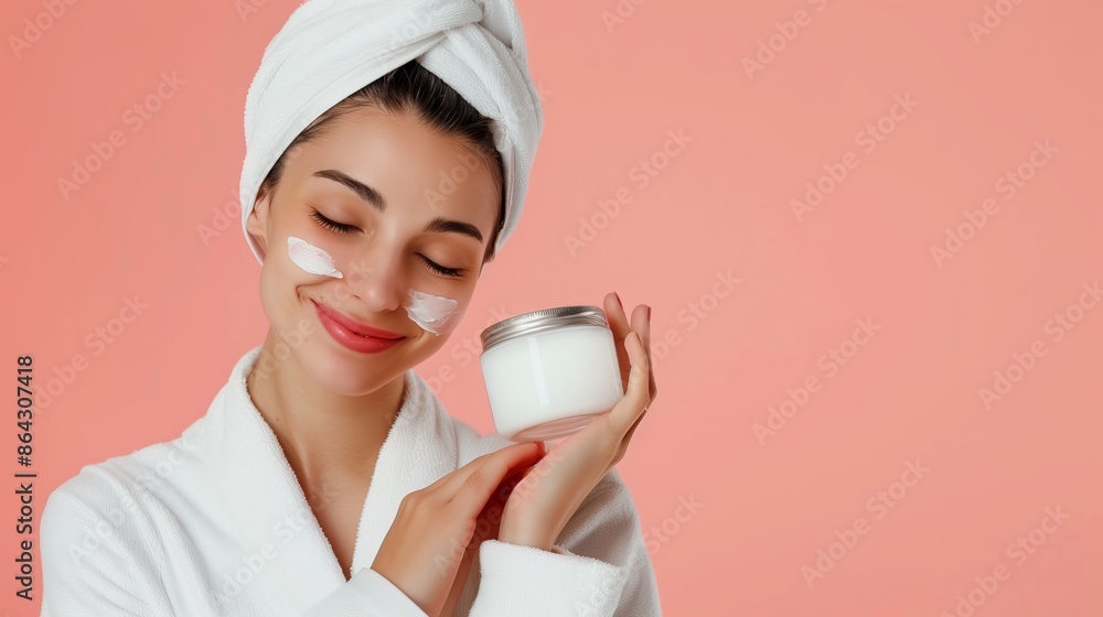 Portrait of laughing beautiful woman applying face cream isolated over pink background, cosmetic concept Portrait of laughing beautiful woman applying face cream isolated over pink background, cosmetic concept