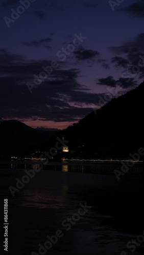 Veduta notturna di monte Isola, con il borgo di Peshiera Maraglio, video verticale photo