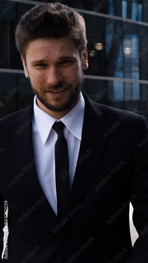 Epic rapidly slow motion shot of smiling businessman entrepreneur outdoor near business centre in formal suit and tie. Clean teal and orange footage on high-speed camera 250 fps. Vertical shot. Epic rapidly slow motion shot of smiling businessman entrepreneur outdoor near business centre in formal suit and tie. Clean teal and orange footage on high-speed camera 250 fps. Vertical shot.