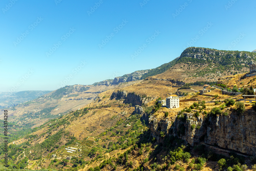 Aerial view of valley between mountains and houses on a cliff. Republic of Lebanon Aerial view of valley between mountains and houses on a cliff. Republic of Lebanon
