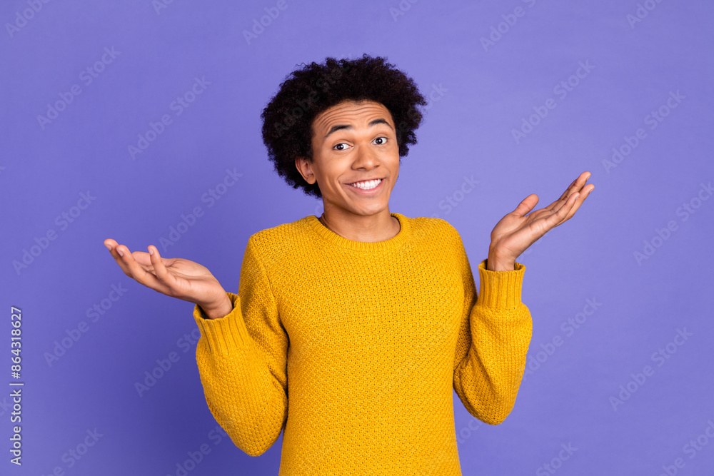 Photo of confused funny man wear trendy yellow clothes raise hands isolated on purple color background Photo of confused funny man wear trendy yellow clothes raise hands isolated on purple color background