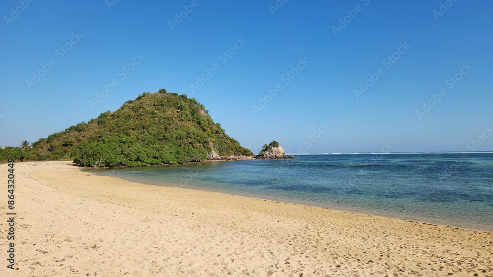 Obraz premium View of Kuta Mandalika beach, with clear blue sky and turquoise ocean, Lombok West Nusa Tenggara - Indonesia l in summer. This beach is famous for its pepper-shaped sand
