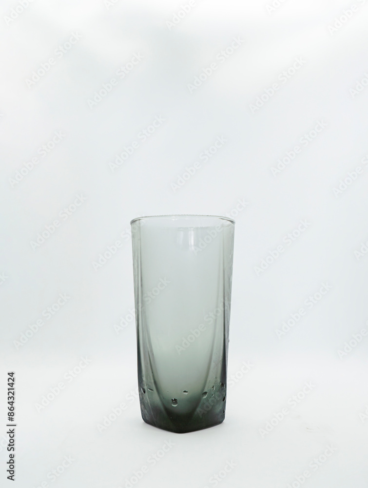 a dark glass with chilled water in it pouring