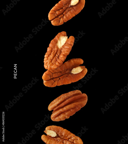 Creative layout made of pecan nuts on the black background. Food concept. Macro concept. photo