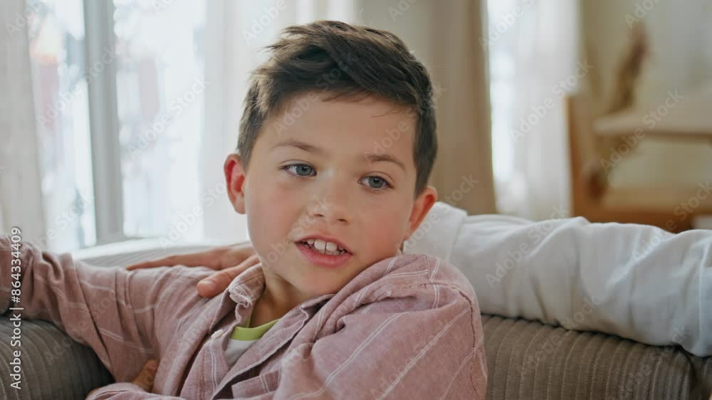 Closeup little boy talking at home sofa. Small kid son resting couch speaking Closeup little boy talking at home sofa. Small kid son resting couch speaking