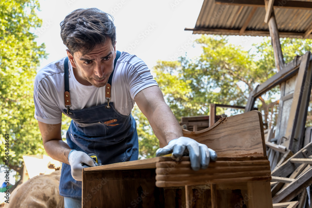 Caucasian carpenter man working with wood in carpentry woodwork Caucasian carpenter man working with wood in carpentry woodwork