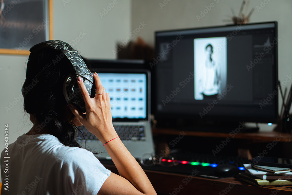Woman with headphones working on photo editing Woman with headphones working on photo editing