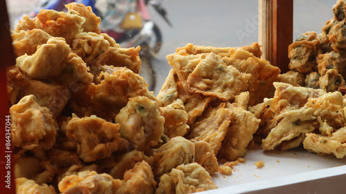 Fried food in a display case sold on the side of the road. Gorengan is a typical Indonesian food. You can find fried food sellers on the side of the road in every city in Indonesia. photo