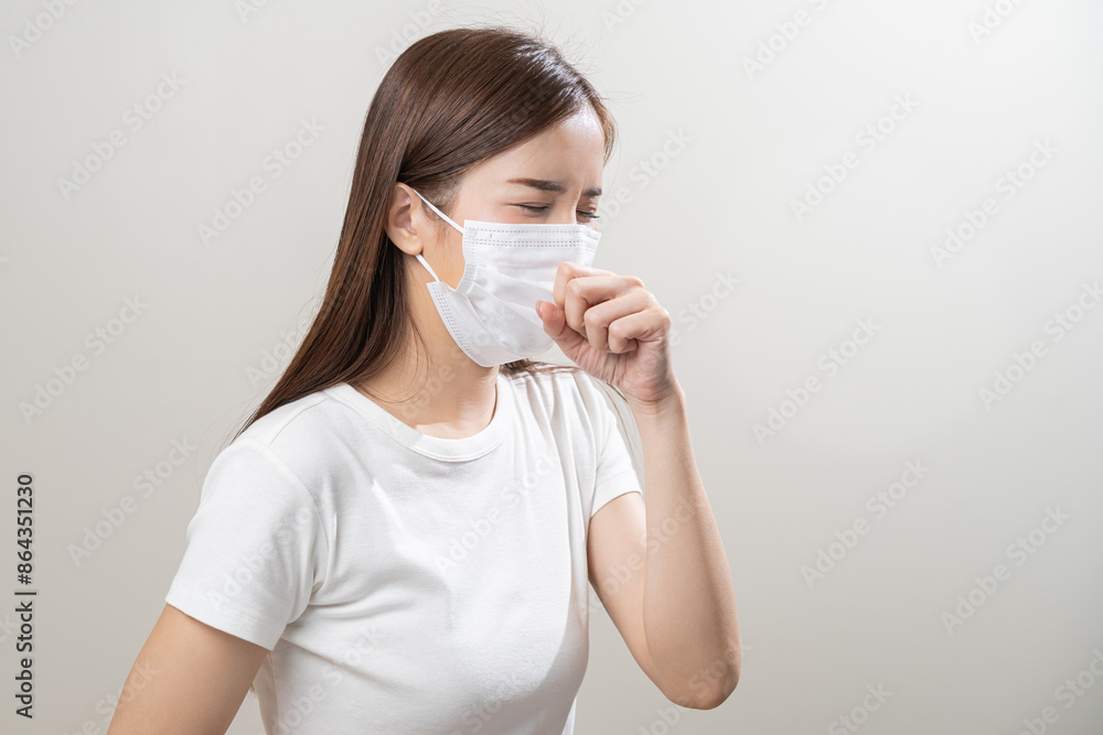 Unhealthy sickness, unwell asian young woman wearing mask coughing, have sore throat, suffering symptom cough feeling bad and healthcare of air pollution and dust, PM2.5 isolated white background. Unhealthy sickness, unwell asian young woman wearing mask coughing, have sore throat, suffering symptom cough feeling bad and healthcare of air pollution and dust, PM2.5 isolated white background.