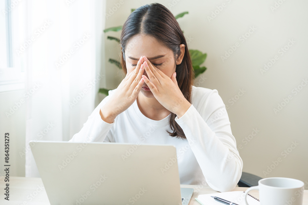 Tired asian young woman burnout, stressed from problem work at desk in office, looking at laptop computer, feeling sick, pain eye strain rubbing dry irritated eyes fatigued working late on deadline. Tired asian young woman burnout, stressed from problem work at desk in office, looking at laptop computer, feeling sick, pain eye strain rubbing dry irritated eyes fatigued working late on deadline.