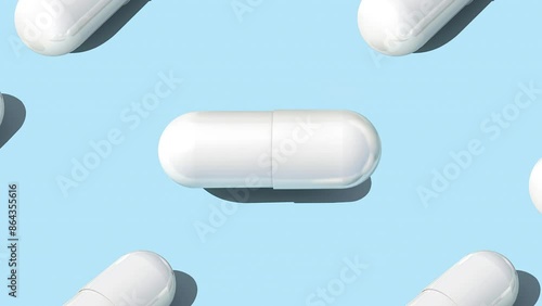White capsule pills on blue background , Medicine concept. Pattern with capsule pills slow motion 4k video. photo