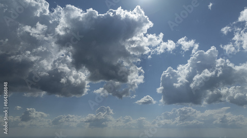  On a sunny midday, the sun radiates brilliantly over the ocean, piercing through cloud cover