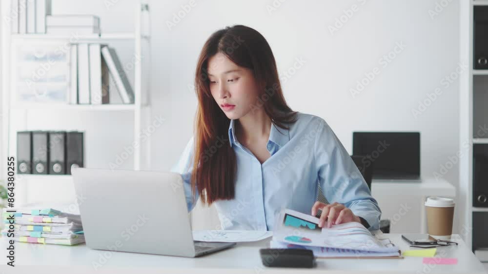 Young woman multitasking between laptop and documents in a modern home office. Ideal for business, productivity, and remote work concepts Young woman multitasking between laptop and documents in a modern home office. Ideal for business, productivity, and remote work concepts