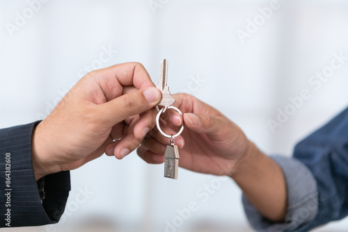 Foto A real estate agent handing over the keys and signing the contract for a new home to a smiling young couple The couple was happy to buy a home and own a new home