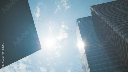 Time lapse photography between buildings in Seoul. Clouds pass through buildings and the sun shines through the clouds.