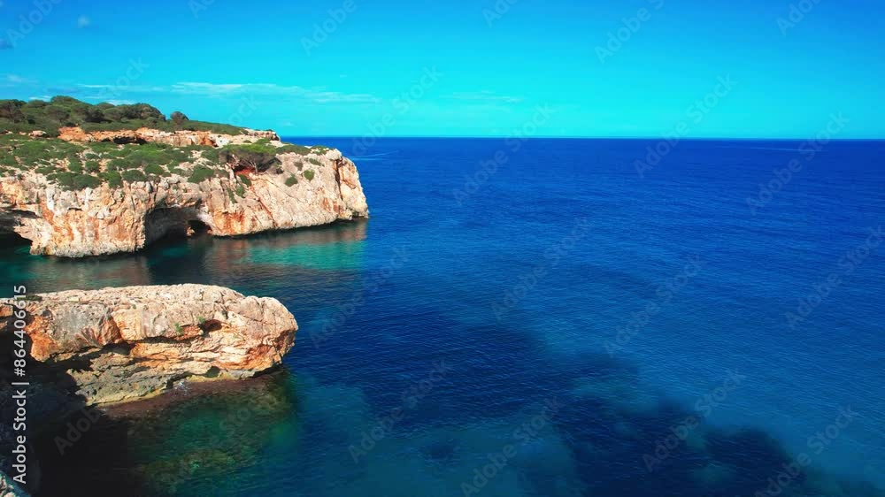 4K Aerial Drone video of the most incredible turquoise blue water color with a unique rocky cliff formation and boats anchored in on a beautiful summer sunny day, Cala Varques secluded beach, Mallorca 4K Aerial Drone video of the most incredible turquoise blue water color with a unique rocky cliff formation and boats anchored in on a beautiful summer sunny day, Cala Varques secluded beach, Mallorca