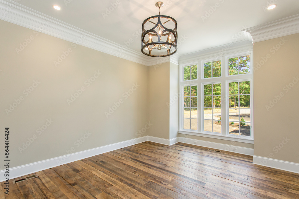 Empty Dining Room with Wooden Floor, Large Windows, and A Modern Chandelier