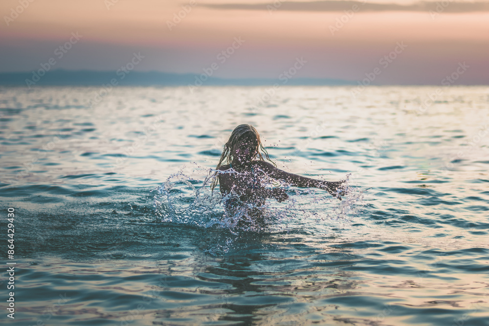 Obraz premium girl splashing in the sea, summer vibes, happiness and joy