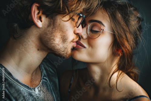 Wallpaper Mural Young people in love. Close-up portrait of young couple in love, hug embrace with romance together, kissing, photographed in studio, dark background.  Torontodigital.ca