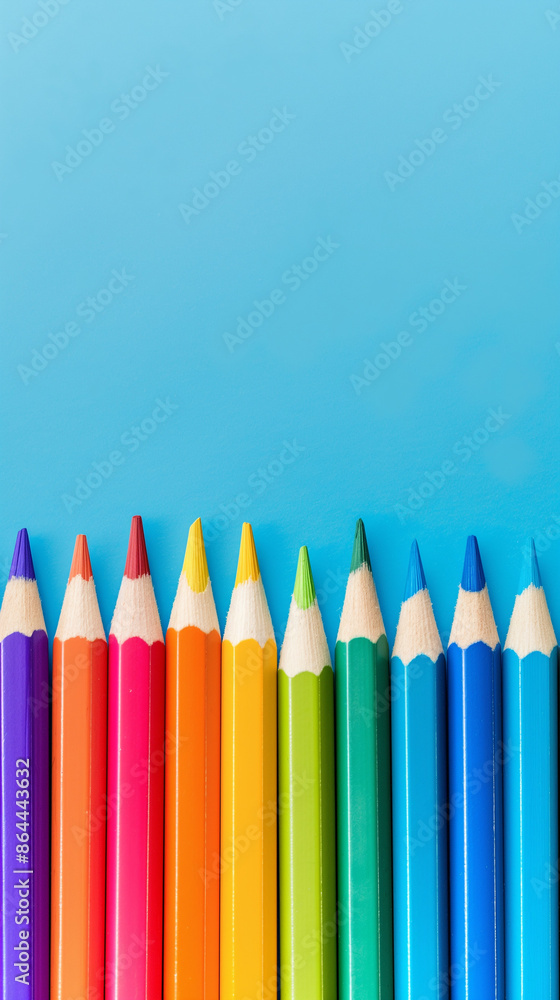 Row of multi-colored pencils on a pink, blue, red and yellow backgrounds Row of multi-colored pencils on a pink, blue, red and yellow backgrounds