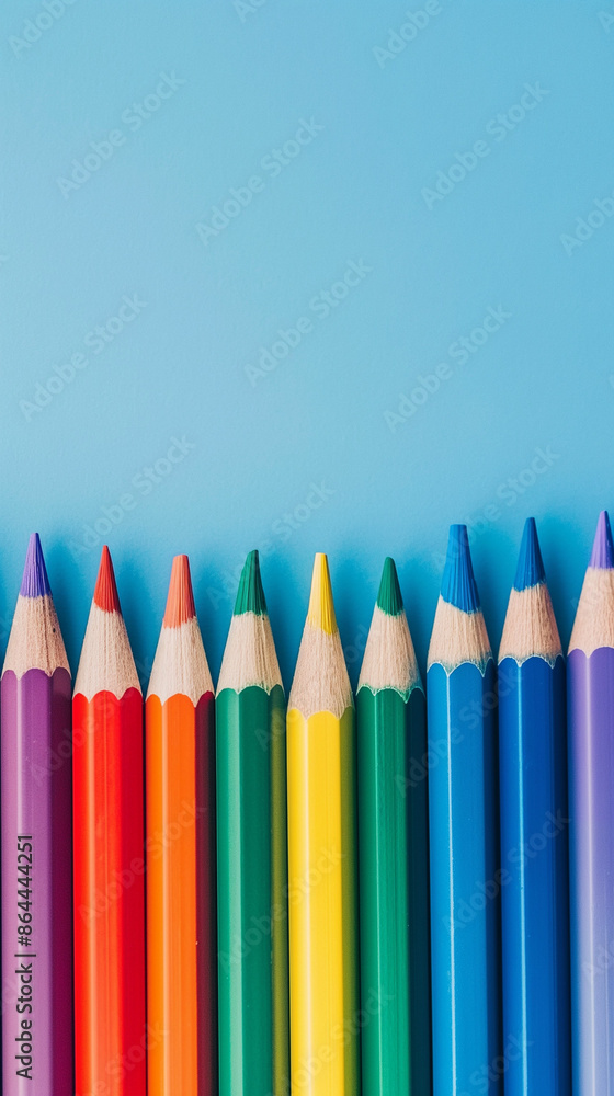 Row of multi-colored pencils on a pink, blue, red and yellow backgrounds Row of multi-colored pencils on a pink, blue, red and yellow backgrounds