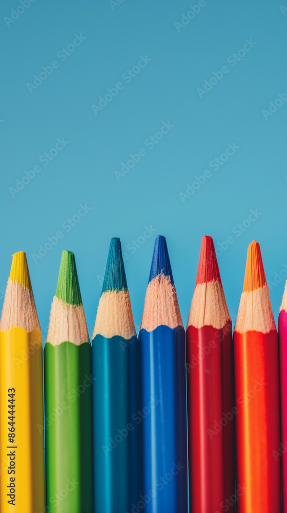 Row of multi-colored pencils on a pink, blue, red and yellow backgrounds Row of multi-colored pencils on a pink, blue, red and yellow backgrounds