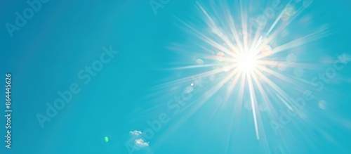 Bright sun against a clear blue sky with room for text