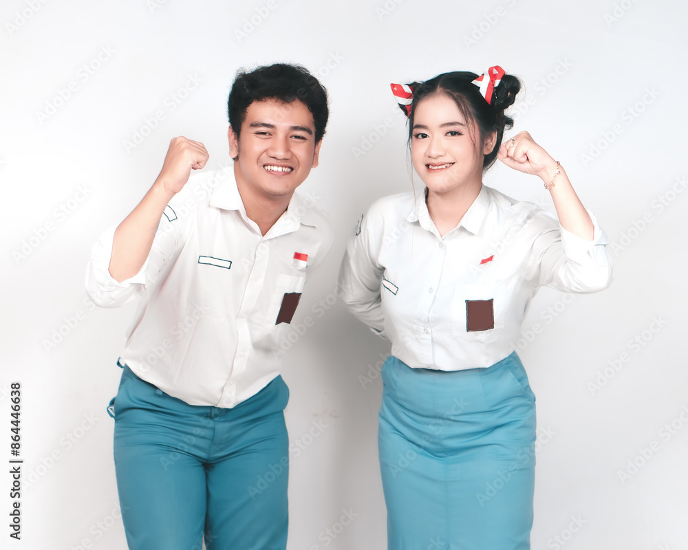 Couple of Indonesian high school students in gray and white uniforms with happy successful expression isolated on white background. Couple of Indonesian high school students in gray and white uniforms with happy successful expression isolated on white background.